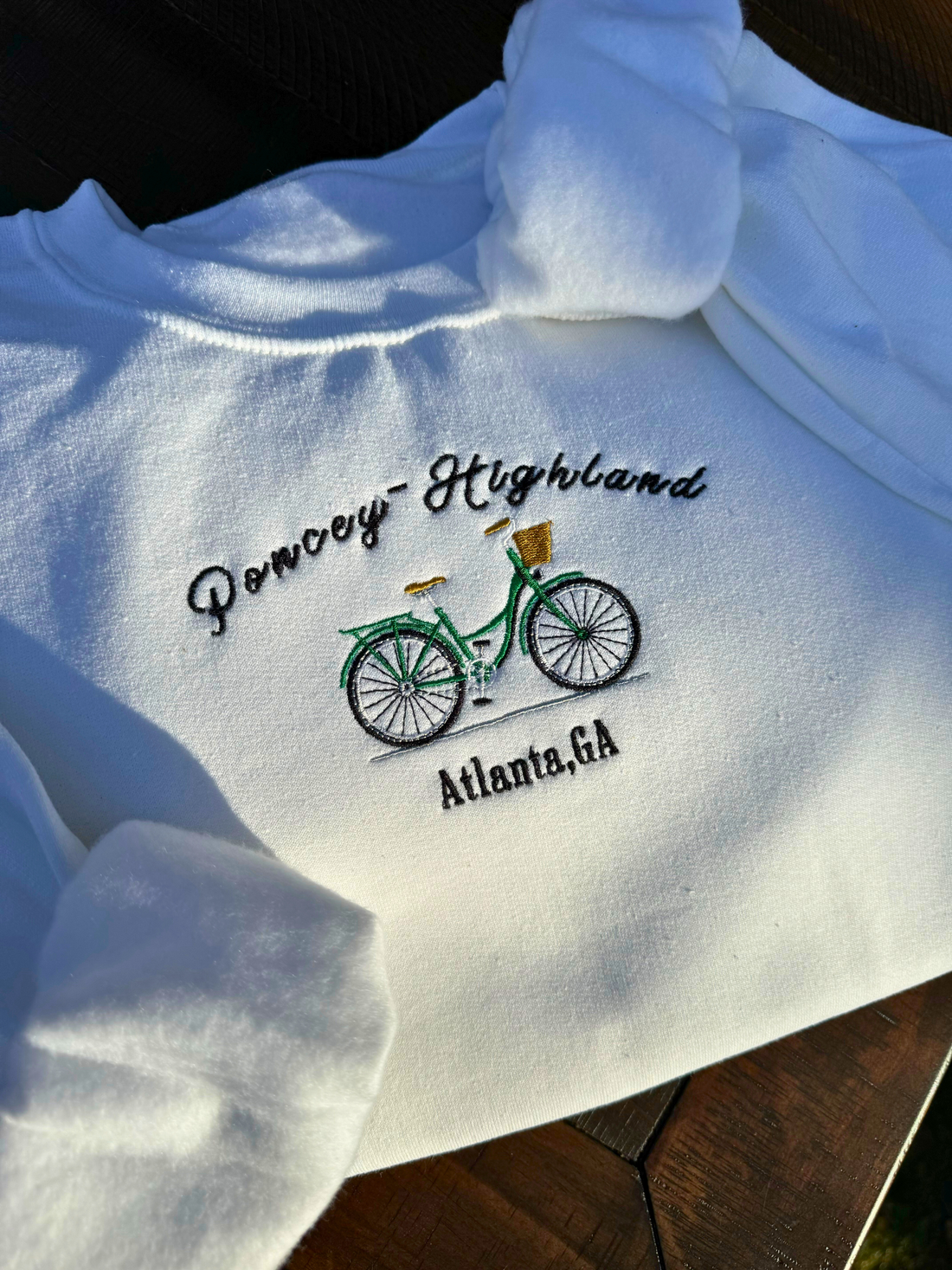 The &quot;Poncey-Highland Heritage Sweater,&quot; embodies the unique charm of this iconic Atlanta neighborhood. This vintage-inspired, embroidered sweater blends comfort with style, celebrating the area&